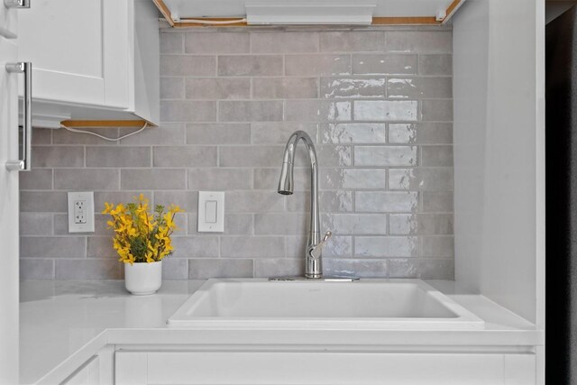 1707 Collier St, Austin, TX 78704 - kitchen view of white cabinetry, decorative backsplash, and light countertops