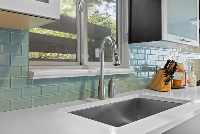 1707 Collier St, Austin, TX 78704 - kitchen view of a sink, decorative backsplash, and light countertops