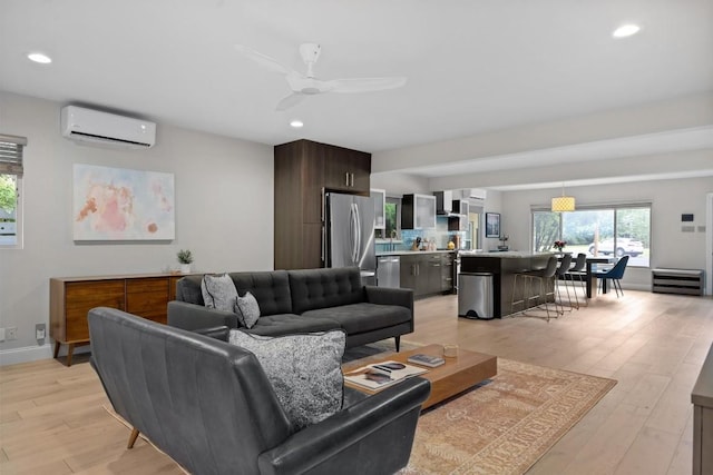 1707 Collier St, Austin, TX 78704 - living room featuring an AC wall unit, recessed lighting, light wood-style floors, ceiling fan, and baseboards