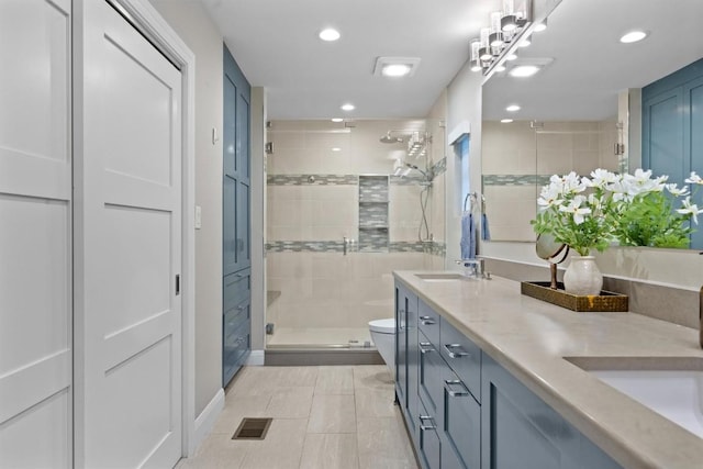 1707 Collier St, Austin, TX 78704 - full bathroom with double vanity, a stall shower, toilet, and recessed lighting