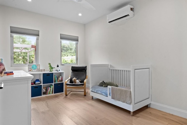 1707 Collier St, Austin, TX 78704 - bedroom with a wall mounted air conditioner, light wood finished floors, multiple windows, recessed lighting, and baseboards