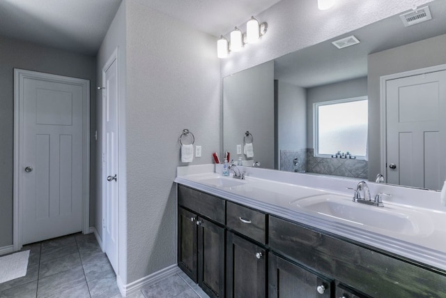 7002 Spirit Of The W Dr, Killeen, TX 76549 - bathroom with double vanity, a textured wall, and tile patterned floors