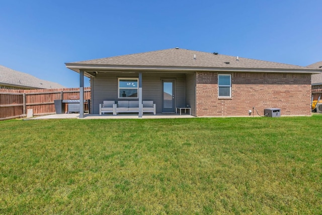 7002 Spirit Of The W Dr, Killeen, TX 76549 - rear view of house featuring a patio, outdoor lounge area, and brick siding