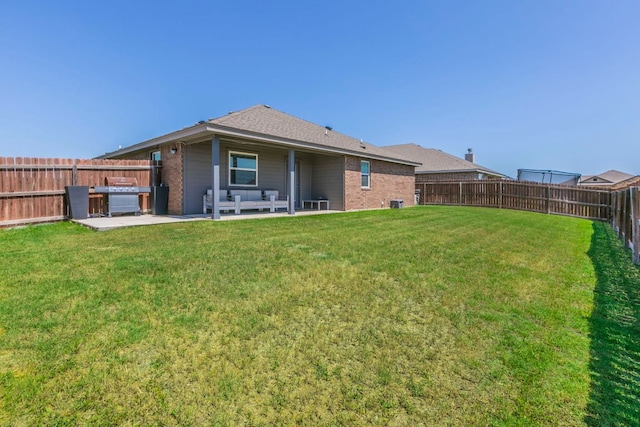 7002 Spirit Of The W Dr, Killeen, TX 76549 - back of property featuring brick siding, a patio area, and a fenced backyard