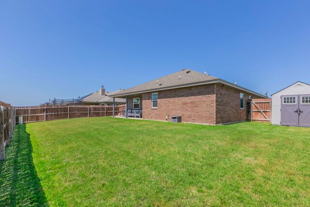 7002 Spirit Of The W Dr, Killeen, TX 76549 - back of house featuring a fenced backyard, brick siding, and a storage shed