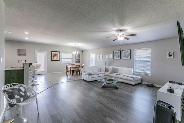 7002 Spirit Of The W Dr, Killeen, TX 76549 - living room featuring plenty of natural light, a chandelier, ceiling fan, a textured ceiling, and wood finished floors