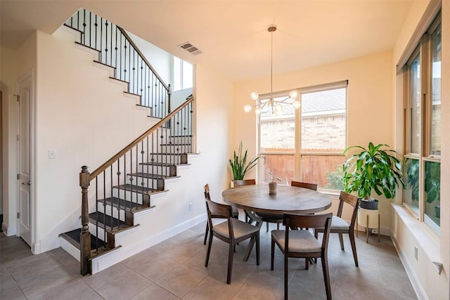 21305 Resource Rd, Pflugerville, TX 78660 - dining space featuring plenty of natural light, a chandelier, stairs, and baseboards