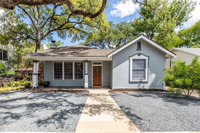 1206 W 22nd 1/2 St, Austin, TX 78705 - view of front of house featuring a porch, stucco siding, and a chimney