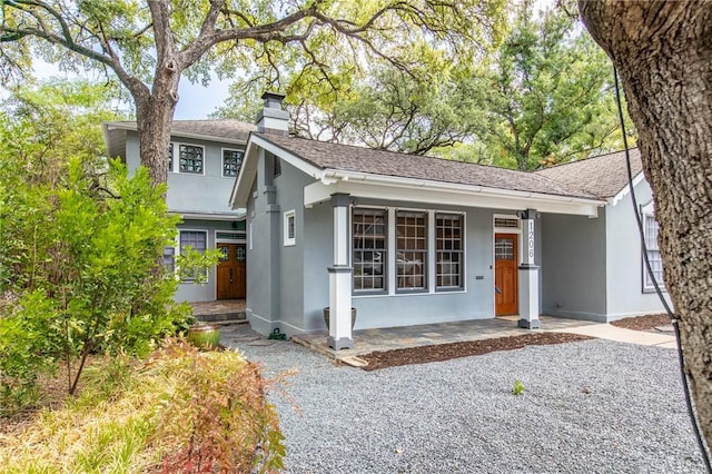 1206 W 22nd 1/2 St, Austin, TX 78705 - ranch-style house featuring stucco siding, a chimney, covered porch, and a shingled roof