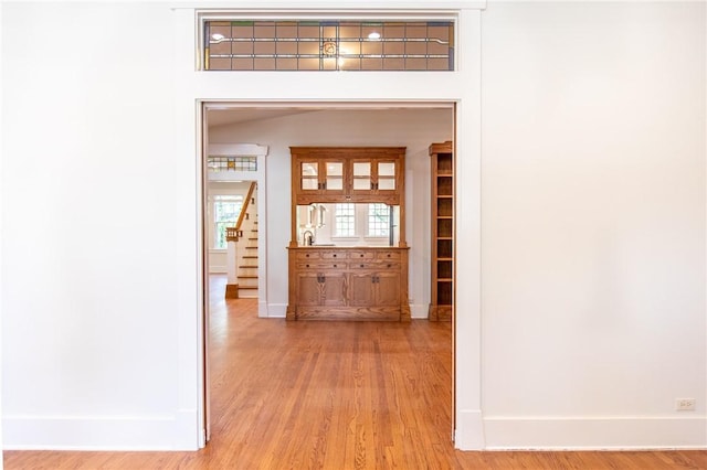 1206 W 22nd 1/2 St, Austin, TX 78705 - hall with baseboards, stairs, and light wood-style flooring