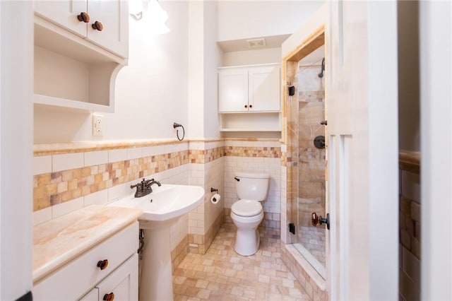 1206 W 22nd 1/2 St, Austin, TX 78705 - full bath with toilet, a stall shower, tile walls, wainscoting, and a sink