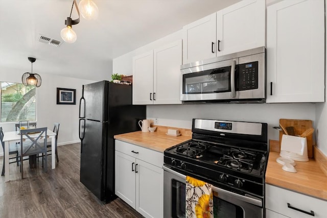 11533 Sandy Loam Trl, Austin, TX 78750 - kitchen with appliances with stainless steel finishes, dark wood finished floors, white cabinets, decorative light fixtures, and butcher block countertops