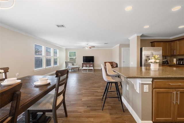 9008 Winter Haven Rd, Austin, TX 78747 - kitchen with stainless steel fridge, ceiling fan, crown molding, dark wood finished floors, and stone counters