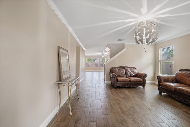 9008 Winter Haven Rd, Austin, TX 78747 - living room with crown molding, wood finished floors, baseboards, ceiling fan, and a chandelier