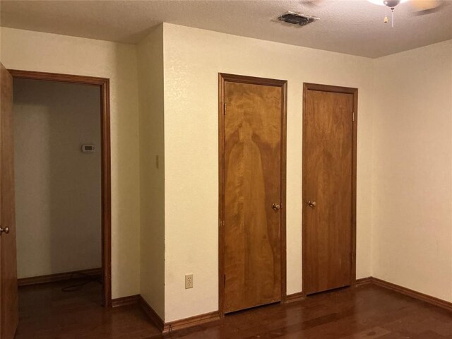 319 Fawnridge St, Georgetown, TX 78628 - unfurnished bedroom featuring two closets and wood finished floors