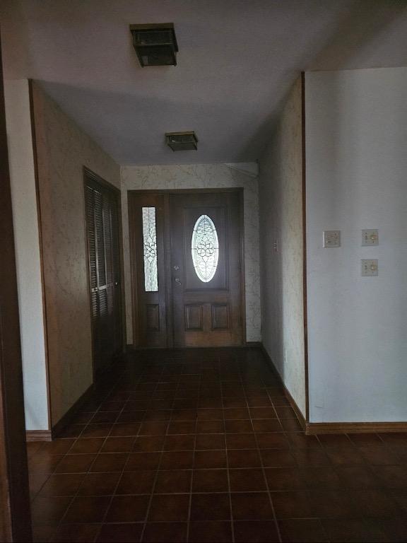 319 Fawnridge St, Georgetown, TX 78628 - foyer featuring dark tile patterned floors and baseboards