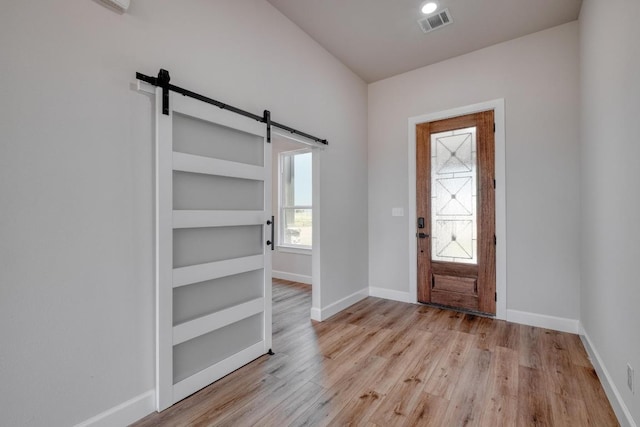 203 Alonzo Dr, Del Valle, TX 78617 - foyer entrance with a barn door and light wood-type flooring