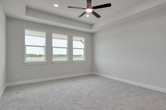 203 Alonzo Dr, Del Valle, TX 78617 - empty room featuring a tray ceiling, recessed lighting, carpet flooring, and a ceiling fan