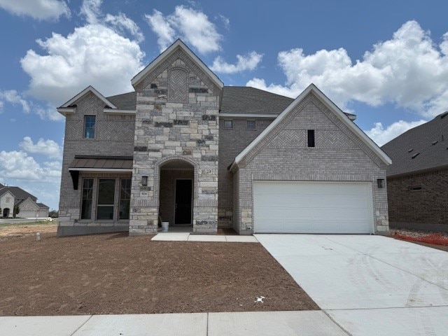 924 Misty Bluff Way, Leander, TX 78641 - french provincial home with driveway, stone siding, brick siding, and a garage