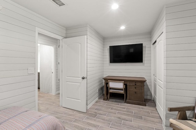810 River Rd, Wimberley, TX 78676 - bedroom with wood tiled floors, recessed lighting, and wood walls