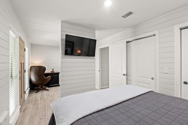 810 River Rd, Wimberley, TX 78676 - bedroom with wood finish floors, wooden walls, and a closet