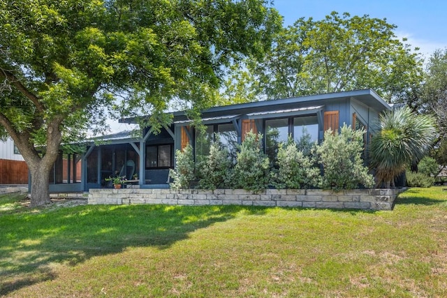 810 River Rd, Wimberley, TX 78676 - view of front of property with a front lawn and a sunroom