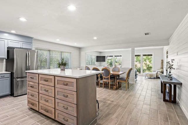 810 River Rd, Wimberley, TX 78676 - kitchen featuring freestanding refrigerator, wood finish floors, light countertops, plenty of natural light, and recessed lighting