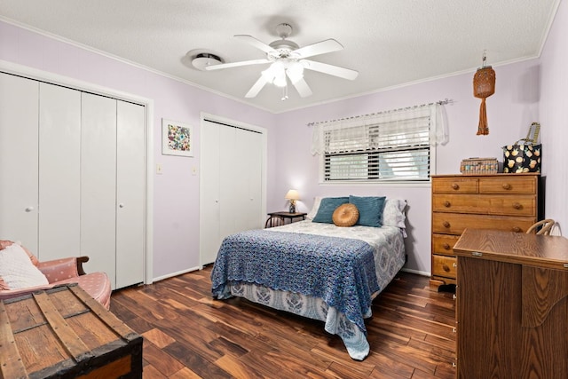 112 Skipcha Trl, Lampasas, TX 76550 - bedroom with two closets, ornamental molding, dark wood-style flooring, a textured ceiling, and a ceiling fan