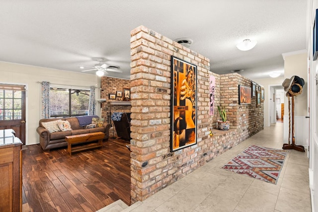 112 Skipcha Trl, Lampasas, TX 76550 - corridor with brick wall and a textured ceiling