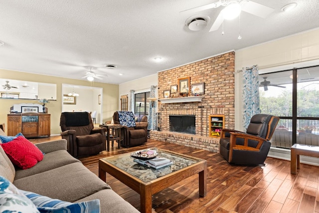 112 Skipcha Trl, Lampasas, TX 76550 - living area with ceiling fan, a textured ceiling, wood finished floors, and a brick fireplace