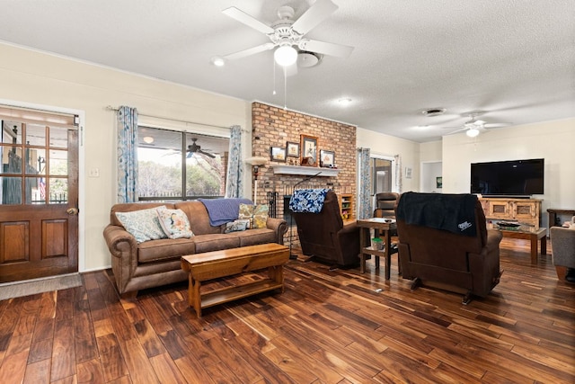 112 Skipcha Trl, Lampasas, TX 76550 - living room with a ceiling fan, dark wood finished floors, a brick fireplace, and a textured ceiling