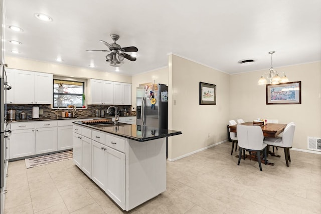 112 Skipcha Trl, Lampasas, TX 76550 - kitchen featuring stainless steel fridge with ice dispenser, a sink, ornamental molding, decorative backsplash, and dark countertops
