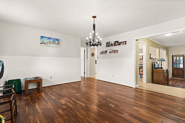 112 Skipcha Trl, Lampasas, TX 76550 - unfurnished living room with a chandelier, wood finished floors, and baseboards