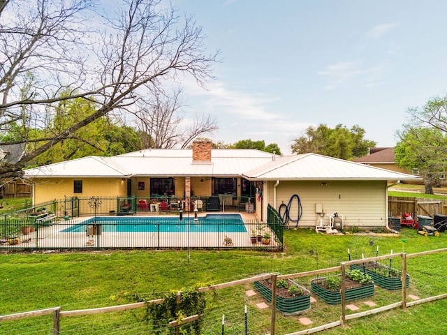 112 Skipcha Trl, Lampasas, TX 76550 - back of property with a garden, a chimney, a patio, and metal roof