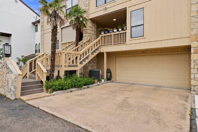 403 Horseshoe Bay Blvd N, Horseshoe Bay, TX 78657 - view of building exterior with a garage, stairway, central AC, and driveway