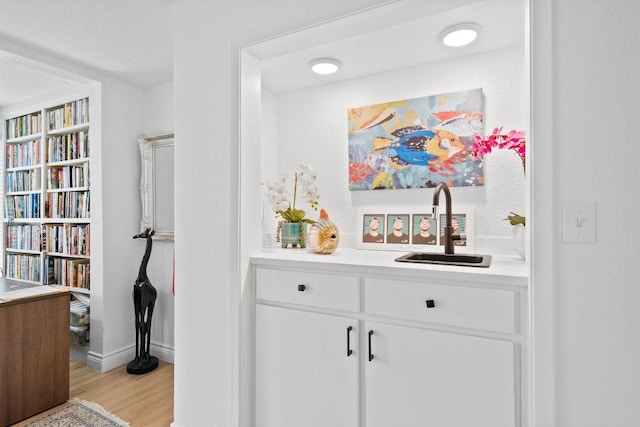 403 Horseshoe Bay Blvd N, Horseshoe Bay, TX 78657 - bar area with a sink, light wood finished floors, and baseboards