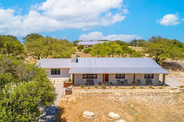 25404 Hamilton Pool Rd, Round Mountain, TX 78663 - ranch-style house featuring covered porch, a chimney, metal roof, and stone siding