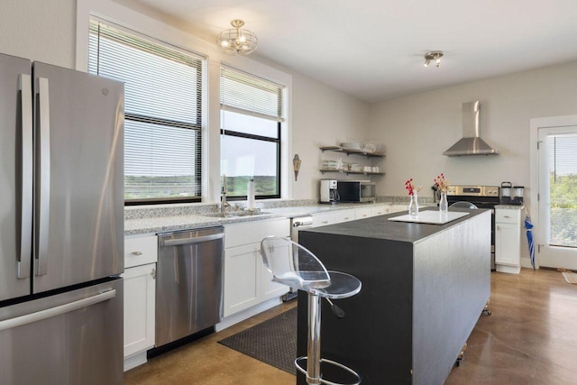 25404 Hamilton Pool Rd, Round Mountain, TX 78663 - kitchen featuring stainless steel appliances, wall chimney exhaust hood, a sink, and white cabinetry