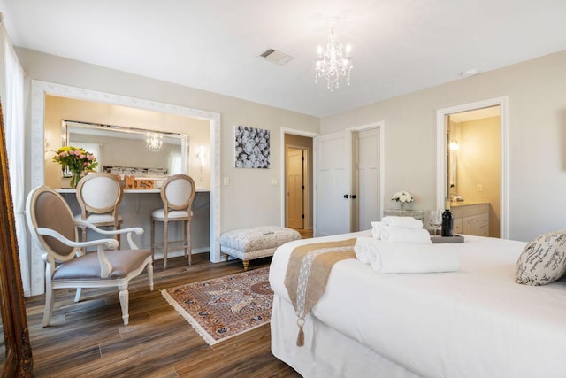25404 Hamilton Pool Rd, Round Mountain, TX 78663 - bedroom with a chandelier, dark wood finished floors, baseboards, and ensuite bathroom