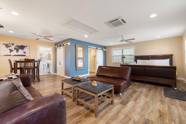 25404 Hamilton Pool Rd, Round Mountain, TX 78663 - living room with ceiling fan, light wood finished floors, baseboards, recessed lighting, and a barn door