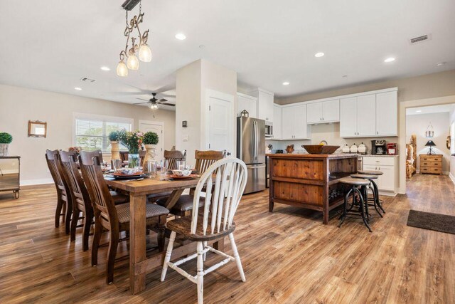 25404 Hamilton Pool Rd, Round Mountain, TX 78663 - dining room with light wood-type flooring, a ceiling fan, recessed lighting, and baseboards