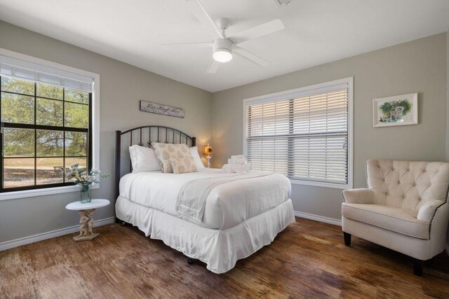 25404 Hamilton Pool Rd, Round Mountain, TX 78663 - bedroom featuring wood finished floors, baseboards, and ceiling fan