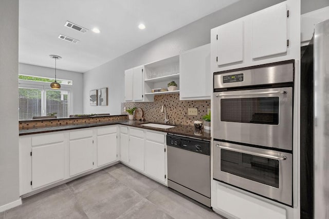 8316 Greenslope Dr Unit A, Austin, TX 78759 - kitchen with stainless steel appliances, dark countertops, open shelves, a sink, and white cabinetry