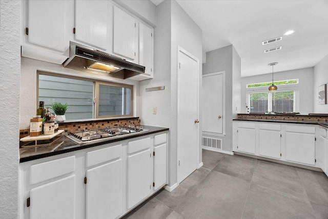 8316 Greenslope Dr Unit A, Austin, TX 78759 - kitchen with stainless steel gas cooktop, dark countertops, white cabinetry, under cabinet range hood, and recessed lighting