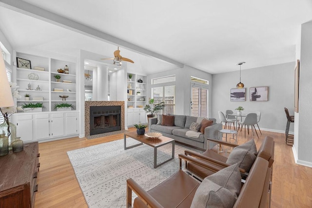 8316 Greenslope Dr Unit A, Austin, TX 78759 - living area with light wood-style floors, baseboards, a fireplace with flush hearth, a ceiling fan, and built in features