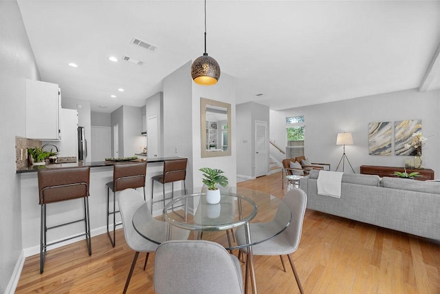 8316 Greenslope Dr Unit A, Austin, TX 78759 - dining room featuring stairs, light wood finished floors, and baseboards