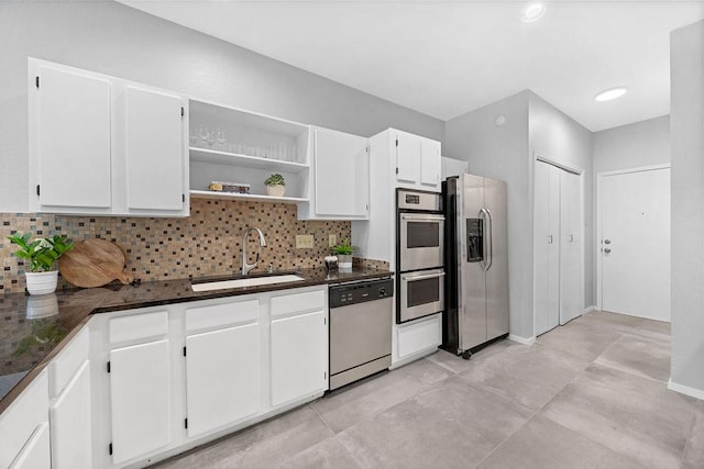 8316 Greenslope Dr Unit A, Austin, TX 78759 - kitchen featuring stainless steel appliances, a sink, decorative backsplash, and white cabinets
