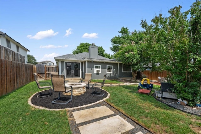 1003 Buttercup Ct, Leander, TX 78641 - back of property featuring an outdoor fire pit, french doors, a chimney, and a patio