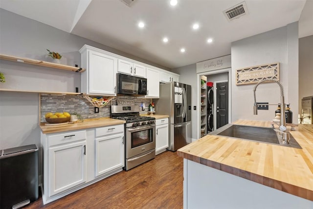 1003 Buttercup Ct, Leander, TX 78641 - kitchen featuring wood counters, appliances with stainless steel finishes, a sink, tasteful backsplash, and recessed lighting