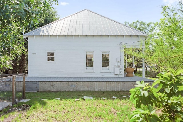 1211 E 13th St, Austin, TX 78702 - view of home's exterior with a wooden deck, metal roof, and a standing seam roof
